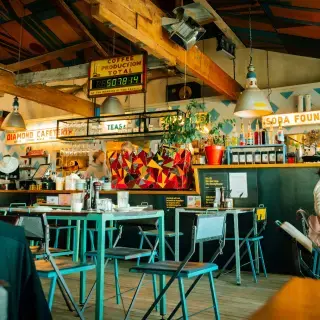 The supplied square Whittle crop focusing on the café's colourful central counter and seating.